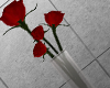 long vase of red roses